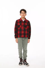 A boy in red flannel plaid shacket