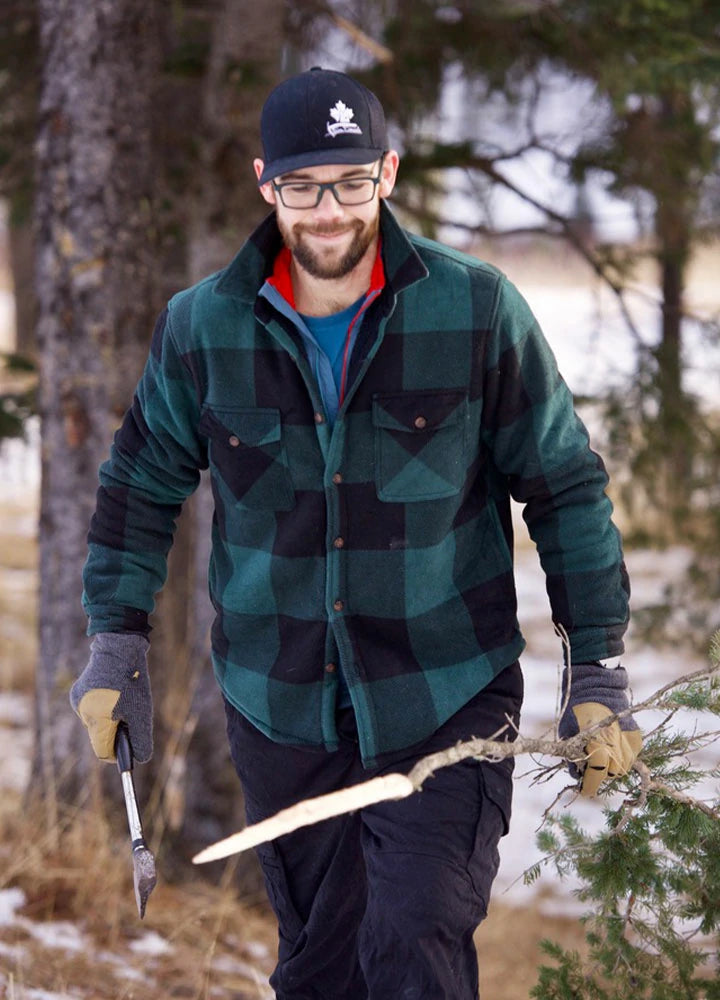 Front view of a man in a black green men's plaid sherpa lined shirt jacket with an axe in hand