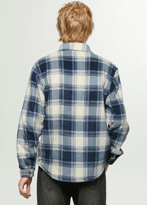 Back view of a man wearing an ocean blue white men's sherpa lined durable plaid jacket 