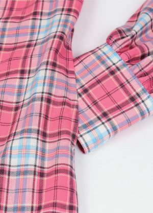 Close-up of women's pearl snap pink flannel shirt dress hand pocket