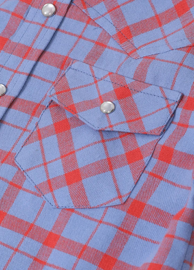 Detail of kid's cornflower blue long-sleeve western shirt pocket with button
