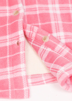 Detailed close-up of womens pink plaid sherpa-lined fleece shirt hem