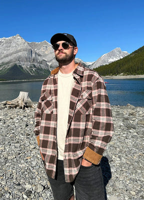 Front view of a man wearing a pink coffee midweight flannel cotton shirt and sunglasses