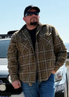 Front view of a man wearing a green men's flannel shirt leaning against a car with one hand in his pocket