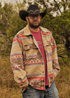 Front view of a man wearing a Khaki men's Aztec shirt jacket with his hands in the pockets