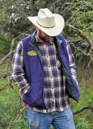  Front view of a man in a coffee white men's stalwart heavyweight cotton plaid shirt looking down at the ground