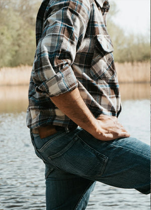 Close-up of the upper body of a man wearing a men's stalwart heavyweight cotton plaid shirt