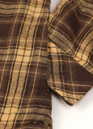 Detailed view of women's brown winter flannel shirt jacket side pocket