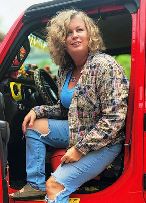 Side view of a woman in a dark green acid-washed soft plaid flannel shirt