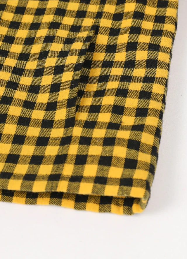 Close-up view of the hand pocket detail on the kid's full zip-up lambswool-lined jacket in yellow black