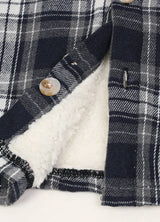 Close-up of the button of boys flannel jacket  