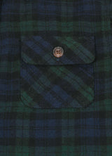 Close-up of pocket with button on kids emerald seas flannel plaid shirt