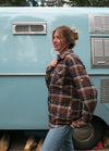 Side view of women in a printed chocolate plaid flannel shirt