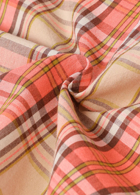 Close-up of kid's melon red sleeveless western vest with plaid fabric