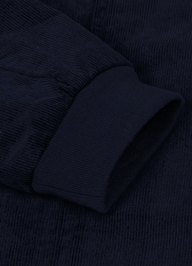 Close-up of the cuff of navy men's winter vintage corduroy solid jacket